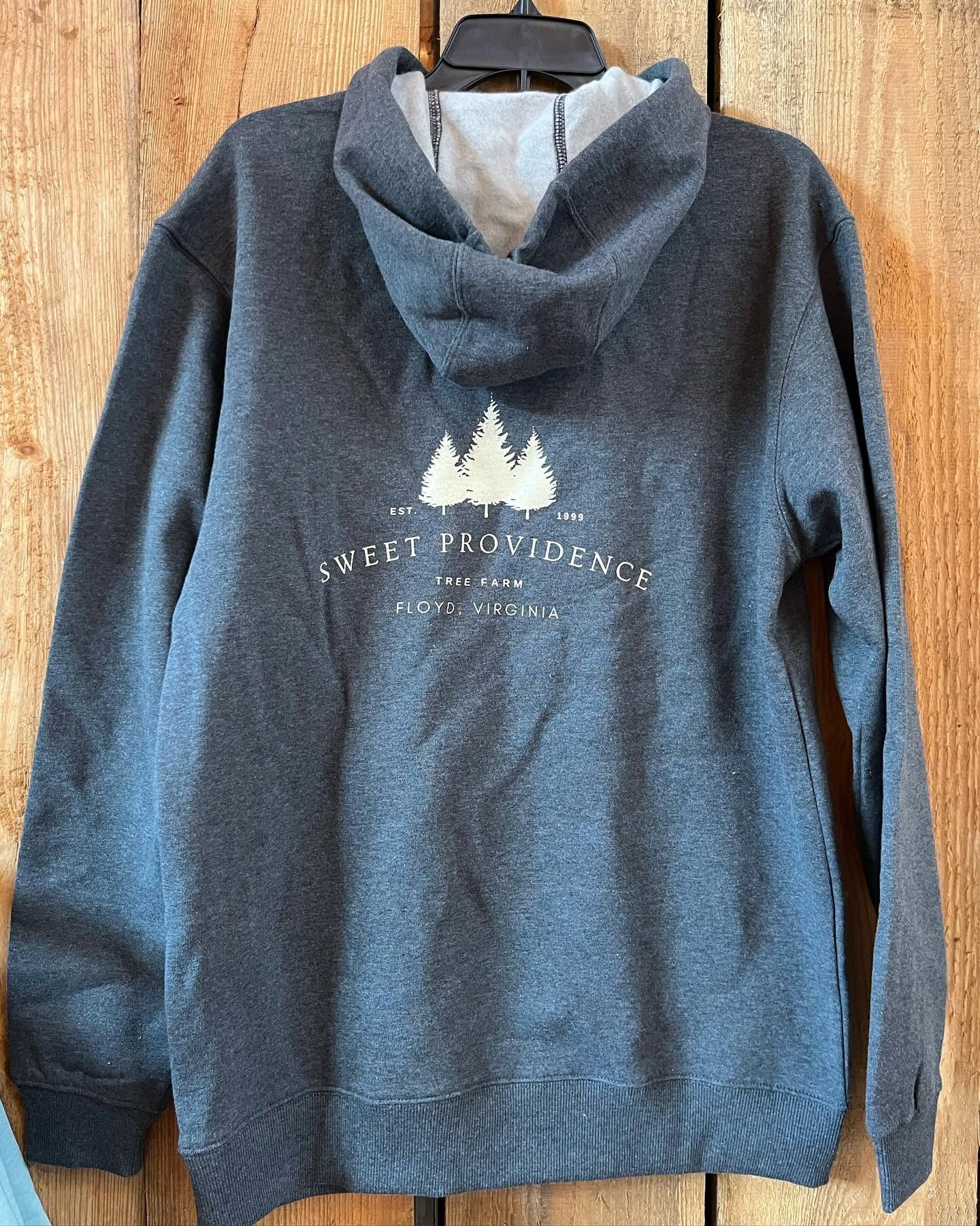A heather-blue hoodie with three firs and “Sweet Providence” printed on the back