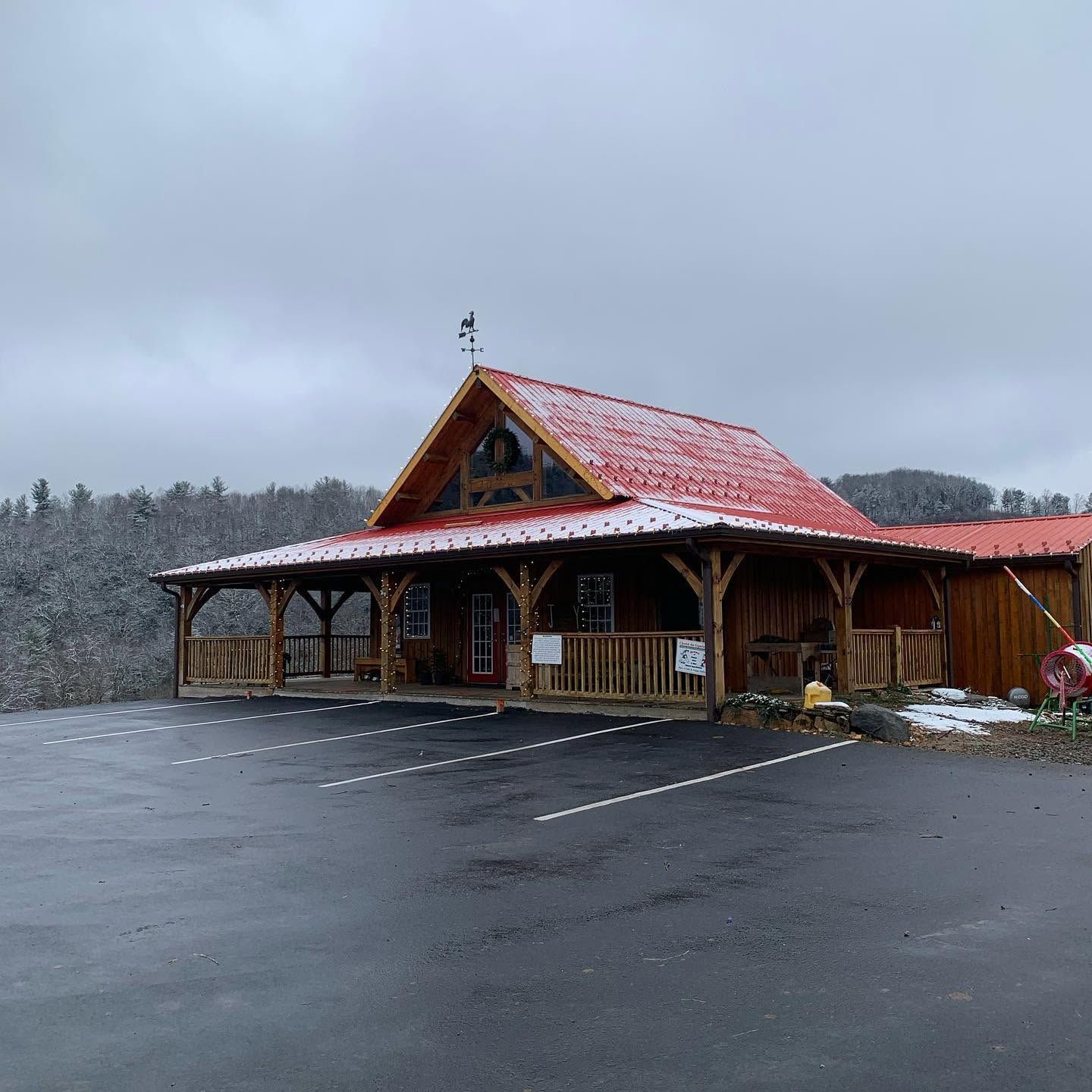 The timber-frame Christmas store with its red metal roof and wide porch
